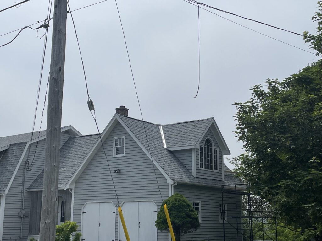 A picture showcasing a roof job done on a house.